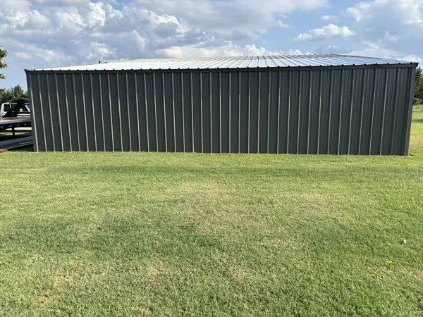 Dark grey metal building on a green lot, Pottsboro, TX