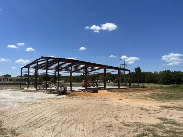 Steel frame with a telehandler setting purlins, Howe, TX
