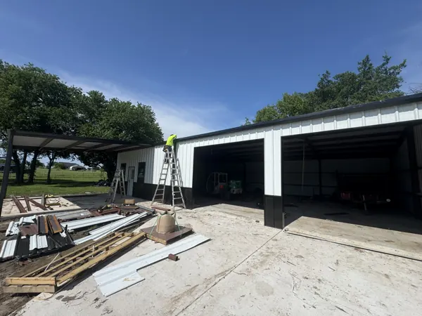 Metal shed with a ladder up during construction, Van Alstyne, TX