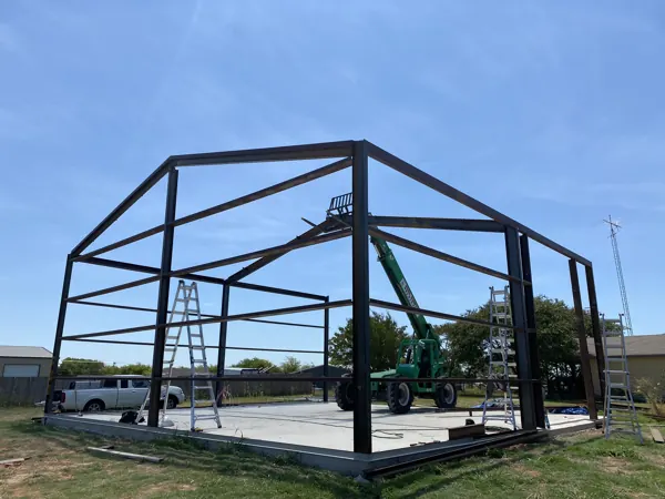 Steel frame with a telehandler under a big sky, Van Alstyne, TX