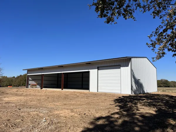 White steel building kit with two roll-up doors, Van Alstyne, TX