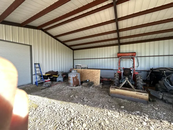 Grey metal shop with an attached carport, Whitesboro, TX