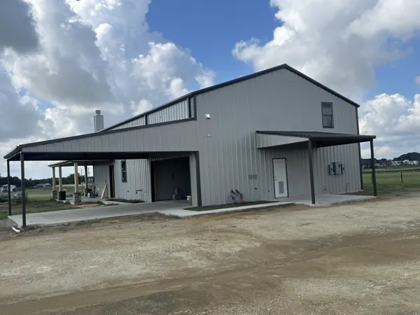 Two-storey barndominium with a standing seam roof and lean-to, Calera, OK