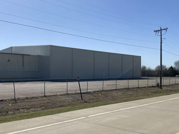Grey metal siding panels on a long building, Sherman, TX