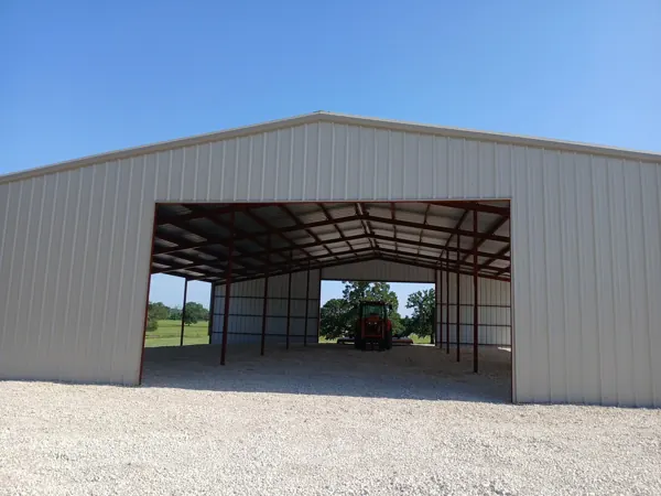 Open-front metal building with a skid steer inside, Denison, TX