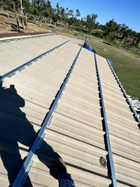 Metal roofing panels going down over the purlins, Denison, TX