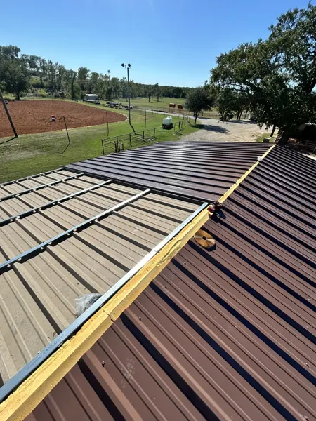 Brown metal roof panels laid on a new roof, Denison, TX