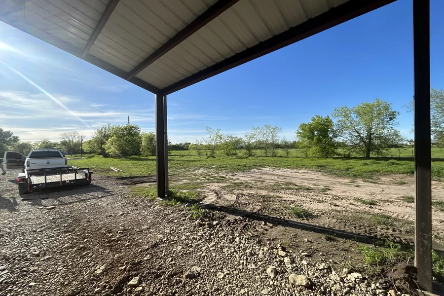 Wide steel carport and canopy structure supplied by Metal Warehouse Inc. in North Texas