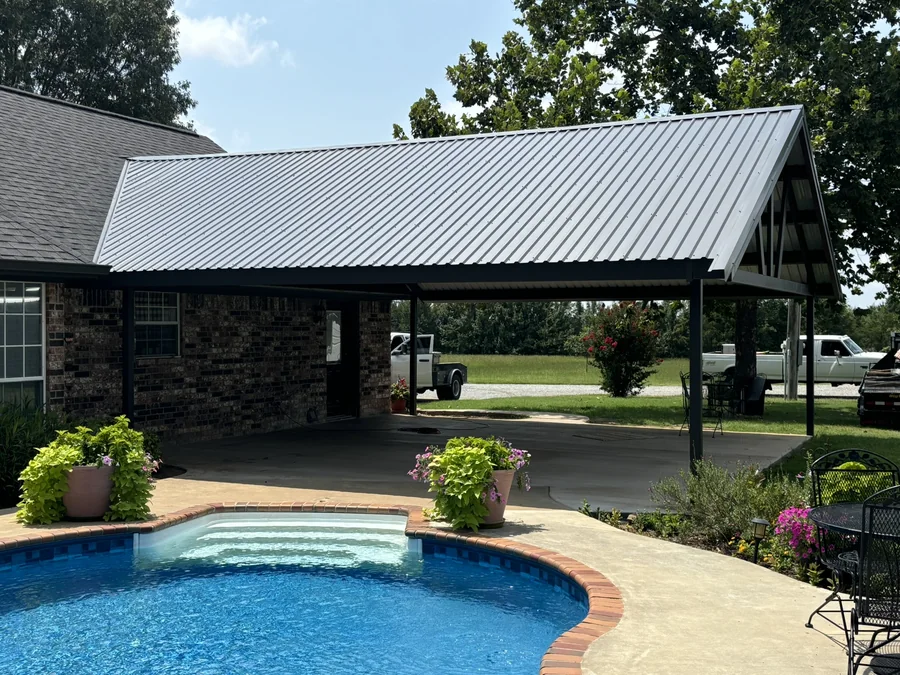 Metal patio cover and canopy over a poolside area